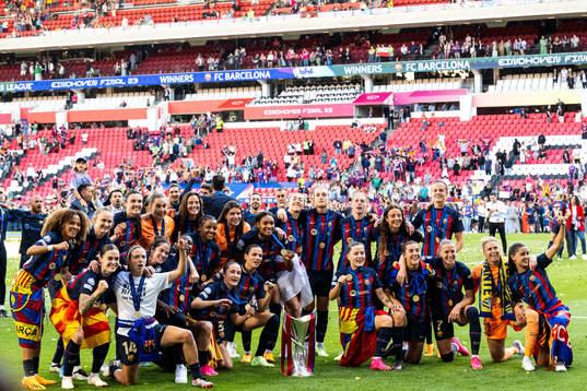 Players of Barcelona celebrate with the trophy