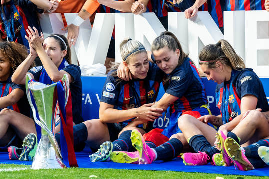 Players of Barcelona celebrate with the trophy
