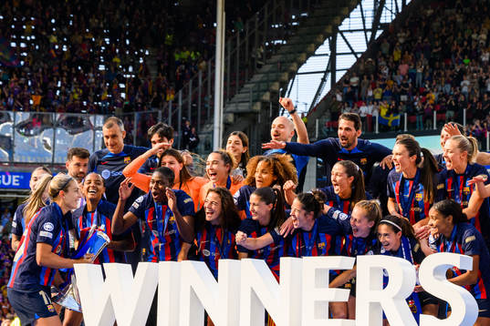 Players of Barcelona lift the trophy