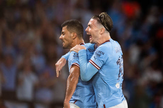 Rodri of Manchester City celebrates with Jack Grealish