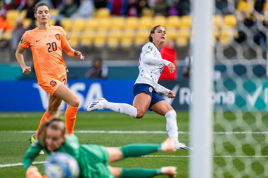 Dominique Janssen and goalkeeper Daphne van Domselaar of Netherlands see Trinity Rodman of USA shoot wide of the goal