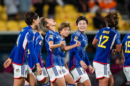 Mina Tanaka of Japan celebrates with team mates