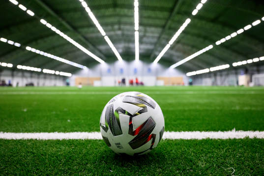 A football on an artificial grass pitch