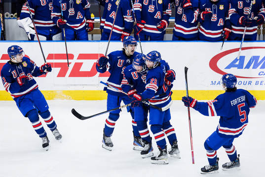 Cutter Gauthier and Seamus Casey celebrate with Isaac Howard