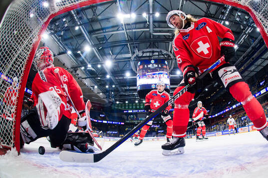 goalkeeper Connor Hughes and Michael Fora of Switzerland