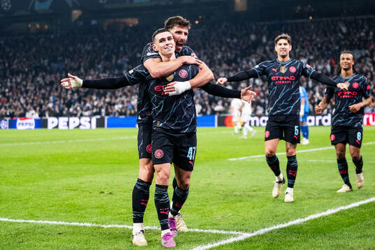 Phil Foden of Manchester City celebrates with Ruben Dias
