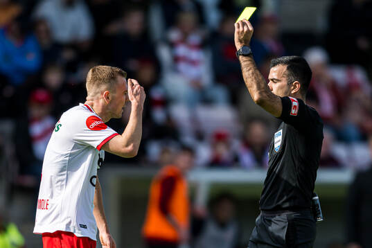 Stian Stray Molde of Fredrikstad after receiving a yellow card by Rohit Saggi, referee,