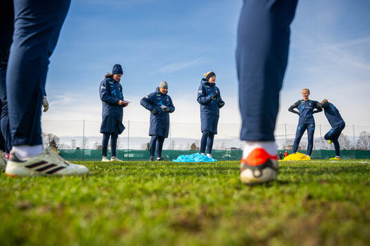 Ingvild Stensland, assistant coach, Lee Skyrme, assistant coach, and Gemma Grainger, head coach of the Norwegian women's national football team,
