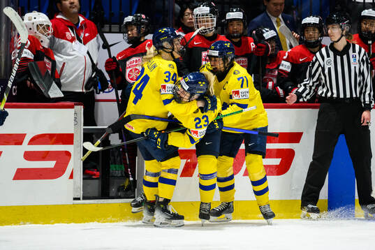 Thea Johansson of Sweden celebrates with teammates