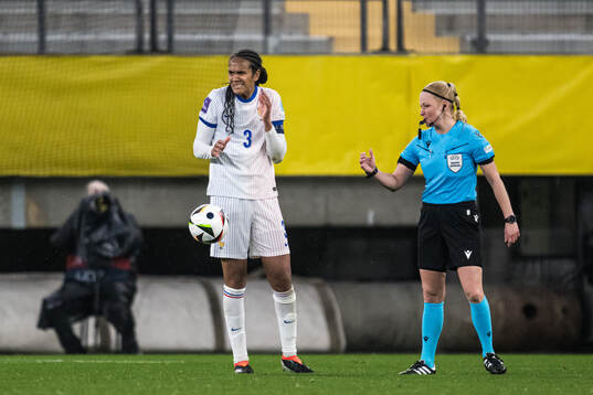 Wendie Renard of France and referee Ewa Augustyn