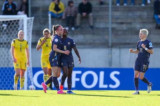 Nelly Las and Omotara Junaid of England celebrate after 1-2