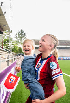 Linnea Holmesveen Moen of Norway with family in the stands