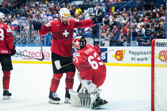 Roman Josi and goaltender Leonardo Genoni celebrates