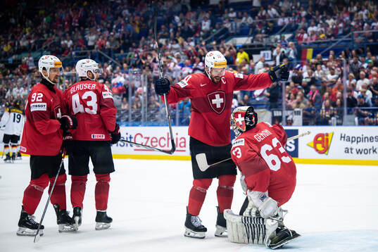 Roman Josi and goaltender Leonardo Genoni of Switzerland