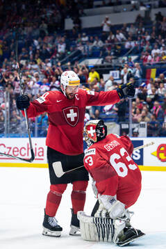 Roman Josi and goaltender Leonardo Genoni of Switzerland