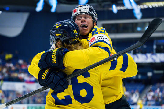 Rasmus Dahlin and Lucas Raymond of Sweden celebrates