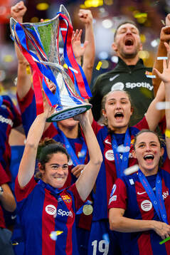 Marta Torrejon of Barcelona lifts the trophy