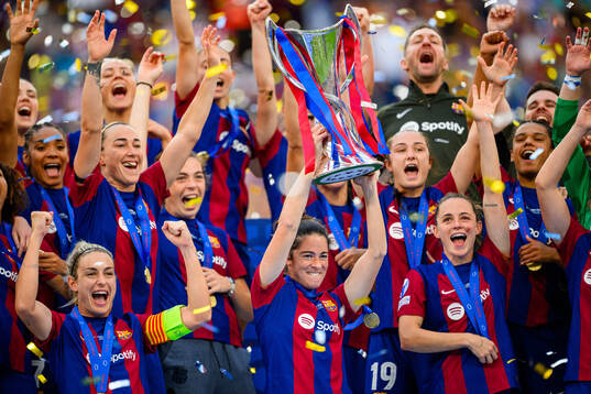 Marta Torrejon of Barcelona lifts the trophy