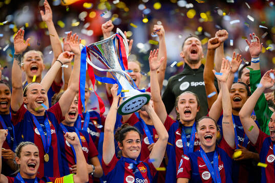 Marta Torrejon of Barcelona lifts the trophy