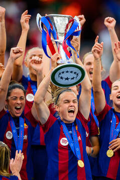 Irene Paredes of Barcelona lifts the trophy
