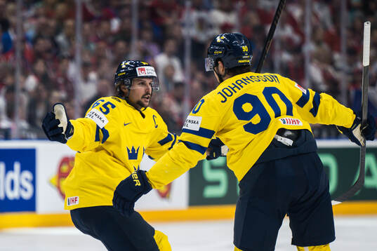 Marcus Johansson of Sweden celebrates with Erik Karlsson