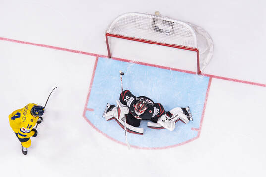 Joel Eriksson Ek of Sweden and goaltender Jordan Bennington
