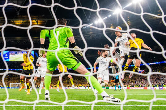 Niclas Fullkrug of Dortmund against goalkeeper Thibaut Courtois, Nacho Fernandez, Antonio Rudiger and Eder Militao