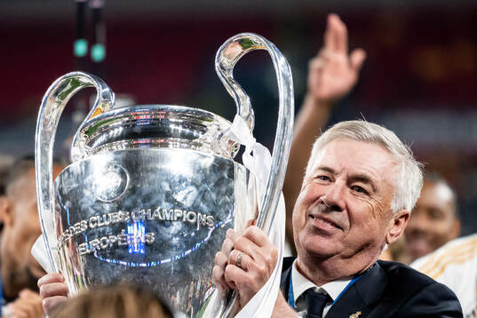 Head coach Carlo Ancelotti of Real Madrid celebrates with the trophy