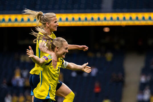 Sofia Jakobsson and Magdalena Eriksson of Sweden celebrate after 1-0