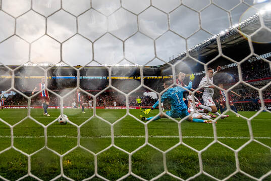 Yussuf Poulsen of Denmark scores 3-1 behind goalkeeper