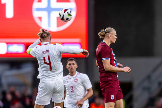 Simon Kjær of Denmark and Erling Braut Haaland of Norway
