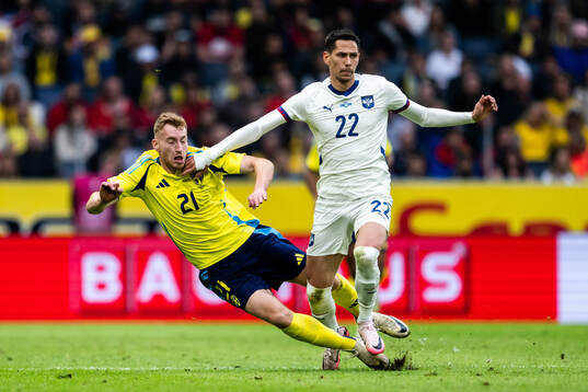 Dejan Kulusevski of Sweden and Sasa Lukic of Serbia