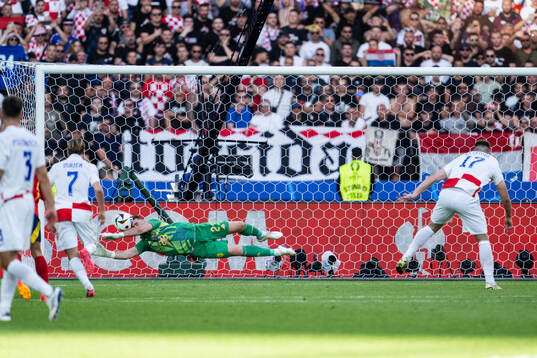 Goalkeeper Unai Simon Mendibil of Spain saves penalty by