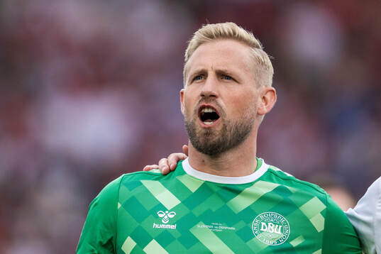 Goalkeeper Kasper Schmeichel of Denmark sings the national