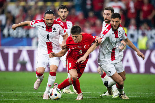 Giorgi Kochorashvili and Lasha Dvali of Georgia against Arda Guler of Türkiye