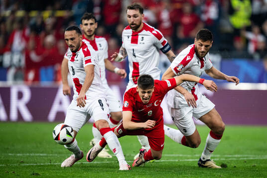 Giorgi Kochorashvili and Lasha Dvali of Georgia against Arda Guler of Türkiye