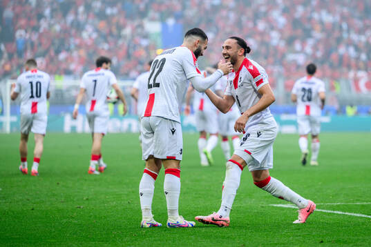 Georges Mikautadze and Giorgi Kochorashvili of Georgia celebrate after scoring 1-1