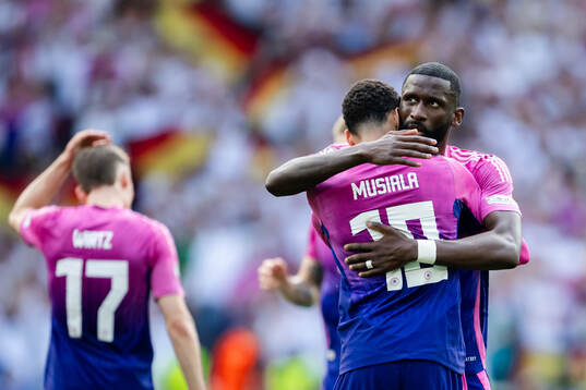 Jamal Musiala and Antonio Ruediger of Germany celebrate