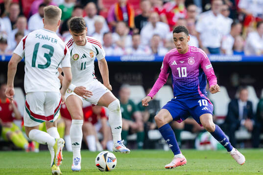 Milos Kerkez of Hungary and Jamal Musiala of Germany