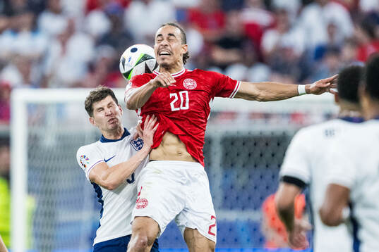 John Stones of England and Yussuf Poulsen of Denmark