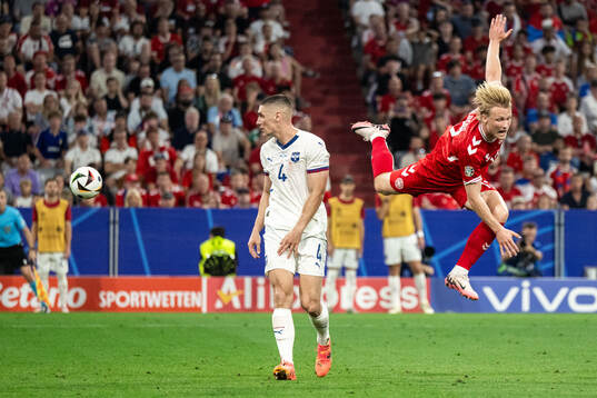 Nikola Milenkovic of Serbia and Kasper Dolberg of Denmark