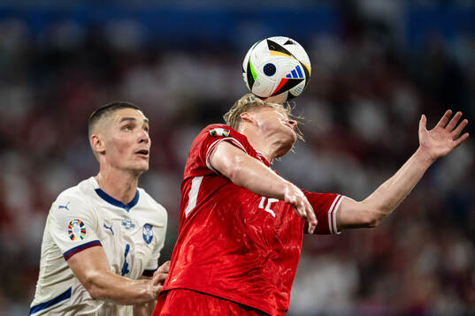 Nikola Milenkovic of Serbia and Kasper Dolberg of Denmark