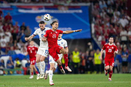 Milos Veljkovic of Serbia and Yussuf Poulsen of Denmark