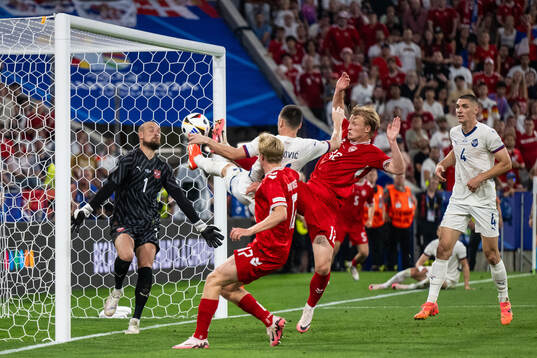 Goalkeeper Predrag Rajkovic and Nikola Milenkovic of Serbia compete for the ball with Kasper Dolberg of Denmark