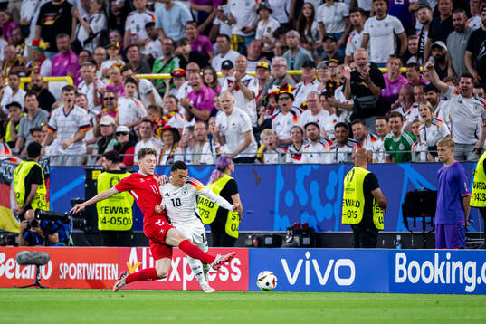 Andreas Skov Olsen of Denmark and Jamal Musiala of Germany