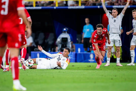 Jamal Musiala of Germany and Thomas Delaney of Denmark