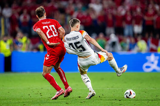 Yussuf Poulsen of Denmark and Nico Schlotterbeck of Germany