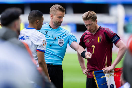 Referee Glenn Nyberg, Kylian Mbappé of France and Kevin De