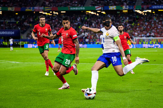 Joao Cancelo of Portugal and Kylian Mbappé of France