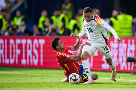 Rodrigo Hernandez of Spain and Jamal Musiala of Germany